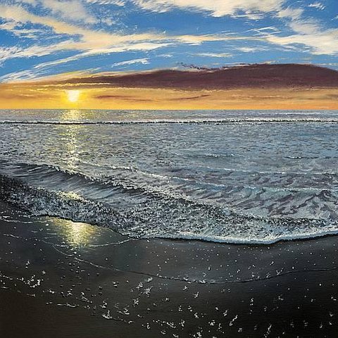 A beach sunset with the sun reflecting in the sand